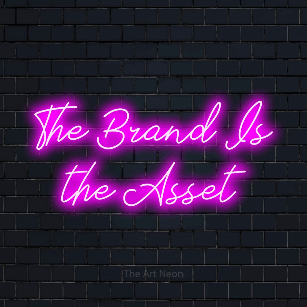 "The Brand Is The Asset" glowing LED neon sign on a black brick wall