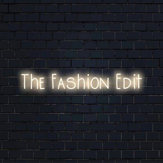 The Fashion Edit LED Neon Sign, soft neon glow on black brick background