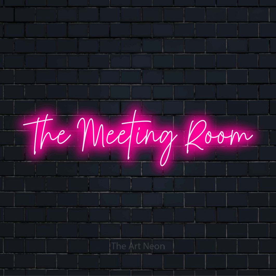"The Meeting Room" script-style LED neon sign on a black brick wall