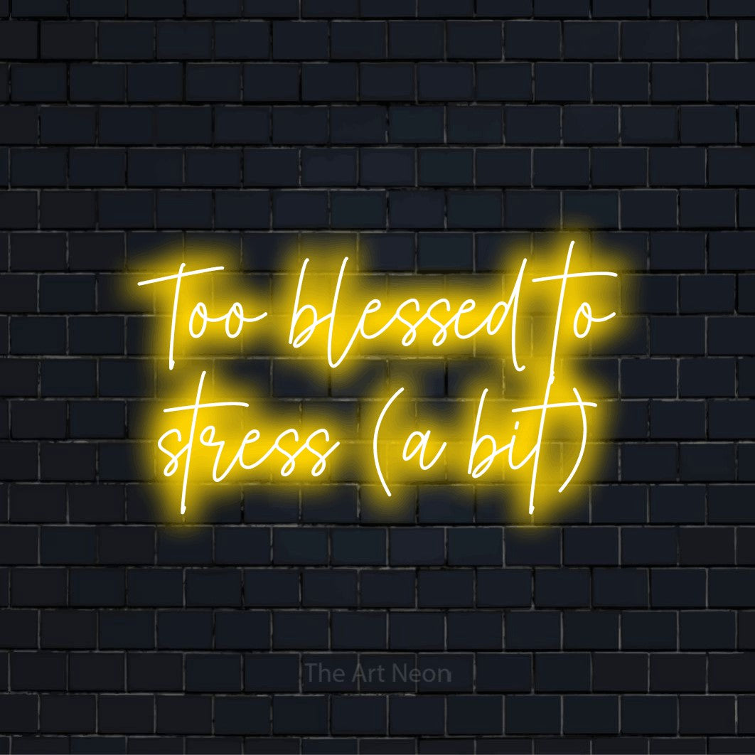 "Too Blessed To Stress (a Bit)" glowing LED neon sign on a black brick wall