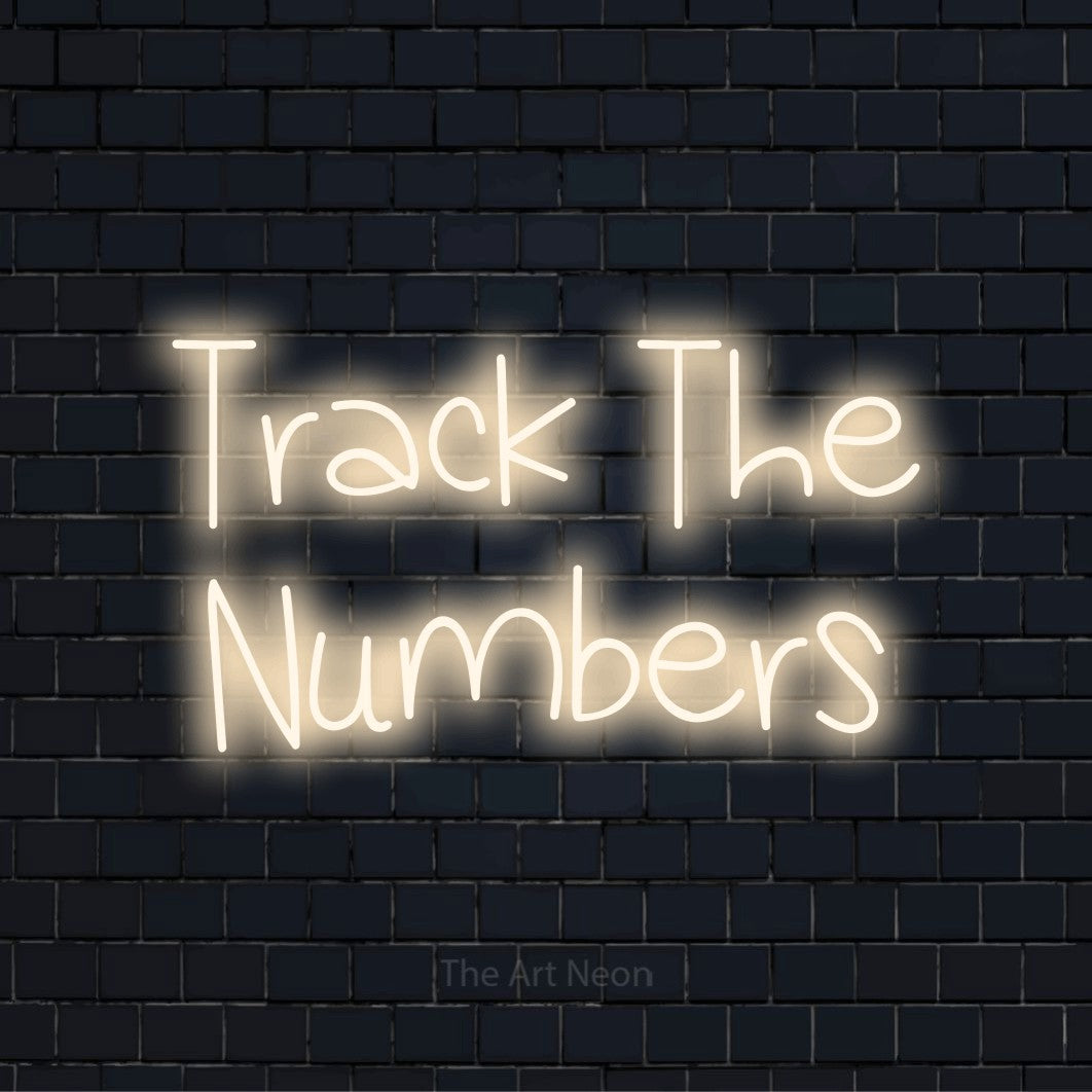 "Track The Numbers" LED neon sign on a black brick wall