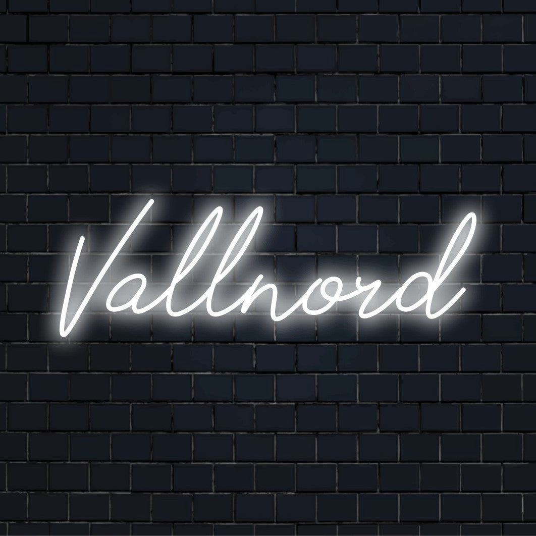 Vallnord Neon Sign, bright neon glow on dark brick wall