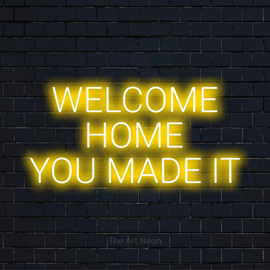 "Welcome Home You Made It" text design with neon effect on a black brick wall