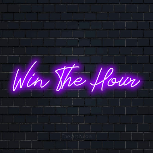 "Win The Hour" script-style LED neon sign on a black brick wall