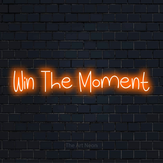 "Win The Moment" text design with neon effect on a black brick wall