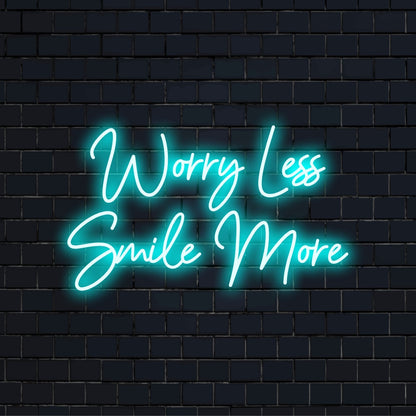 Worry Less Smile More LED Neon Sign, glowing lettering on black brick background