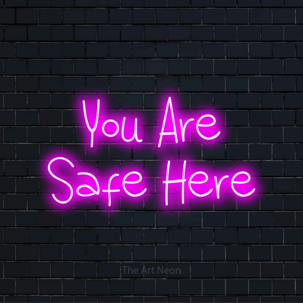 "You Are Safe Here" script-style LED neon sign on a black brick wall