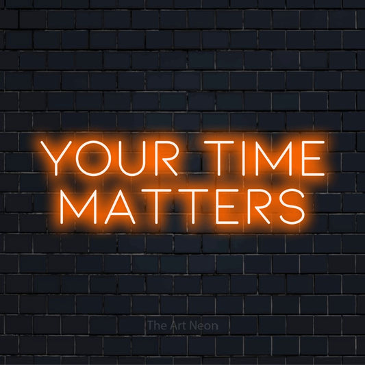 "Your Time Matters" LED neon sign on a black brick wall